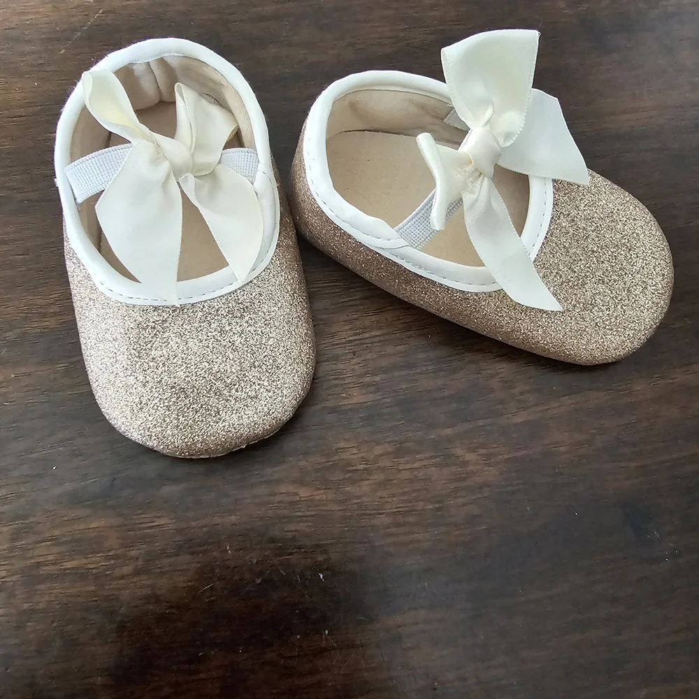 3 pairs of baby/girl shoes—soft, floral, and glittery—in various styles.
